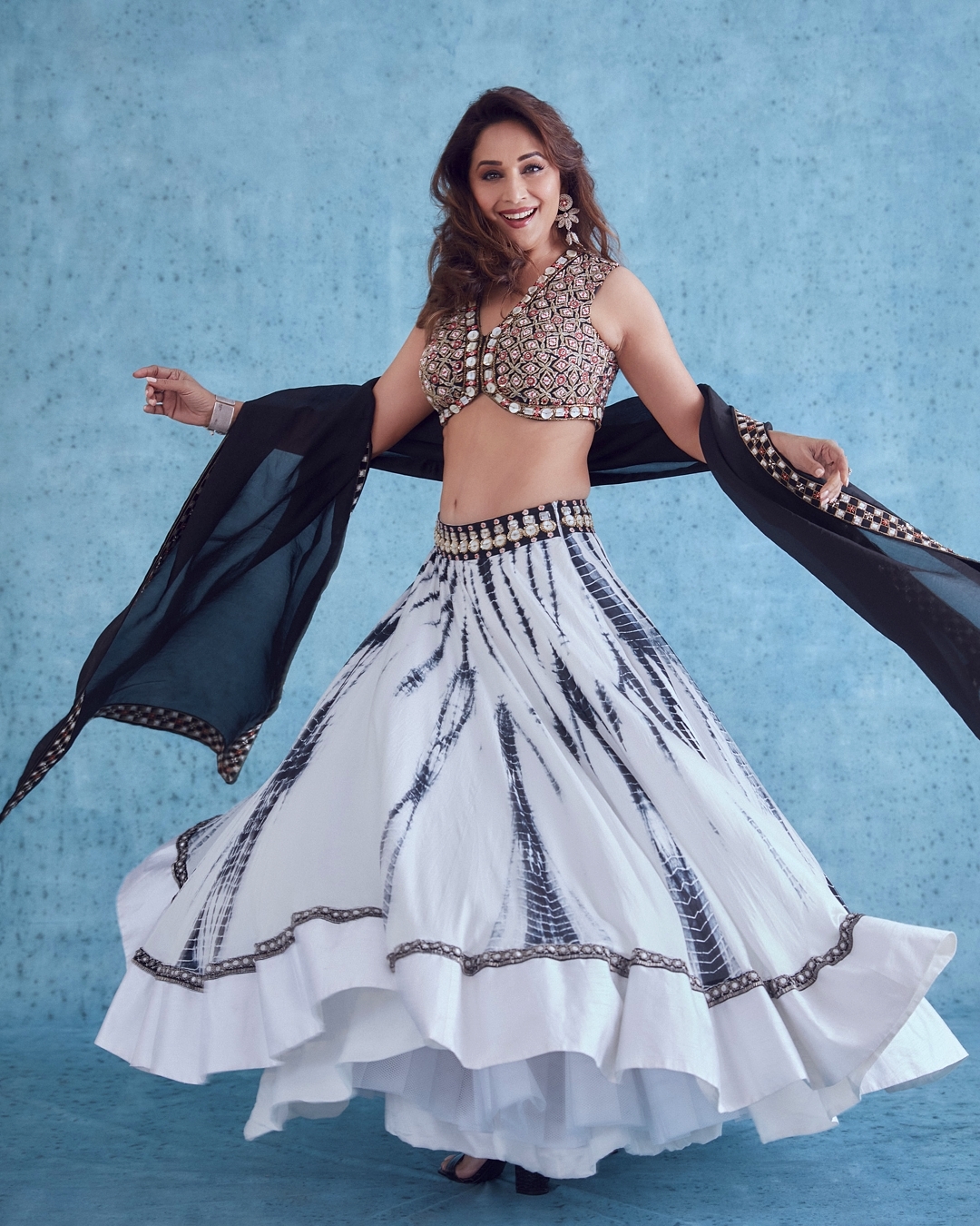  Madhuri Dixit Nene is aging like fine wine. In a latest set of photos, the 'dhak dhak' girl is seen embracing the tie-dye trend in a lehenga and embellished choli. (Image: Instagram)