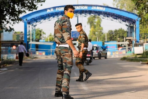 Security personnel patrol after two low intensity explosions reported in the technical area of Jammu Air Force Station in the early hours of Sunday. One caused minor damage to the roof of a building while the other exploded in an open area. (PTI Photo)