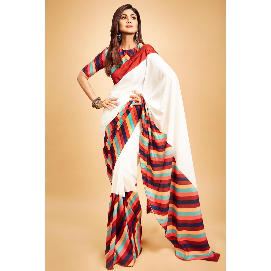 Shilpa Shetty cuts a statusque figure in the white saree with the vibrant border. 