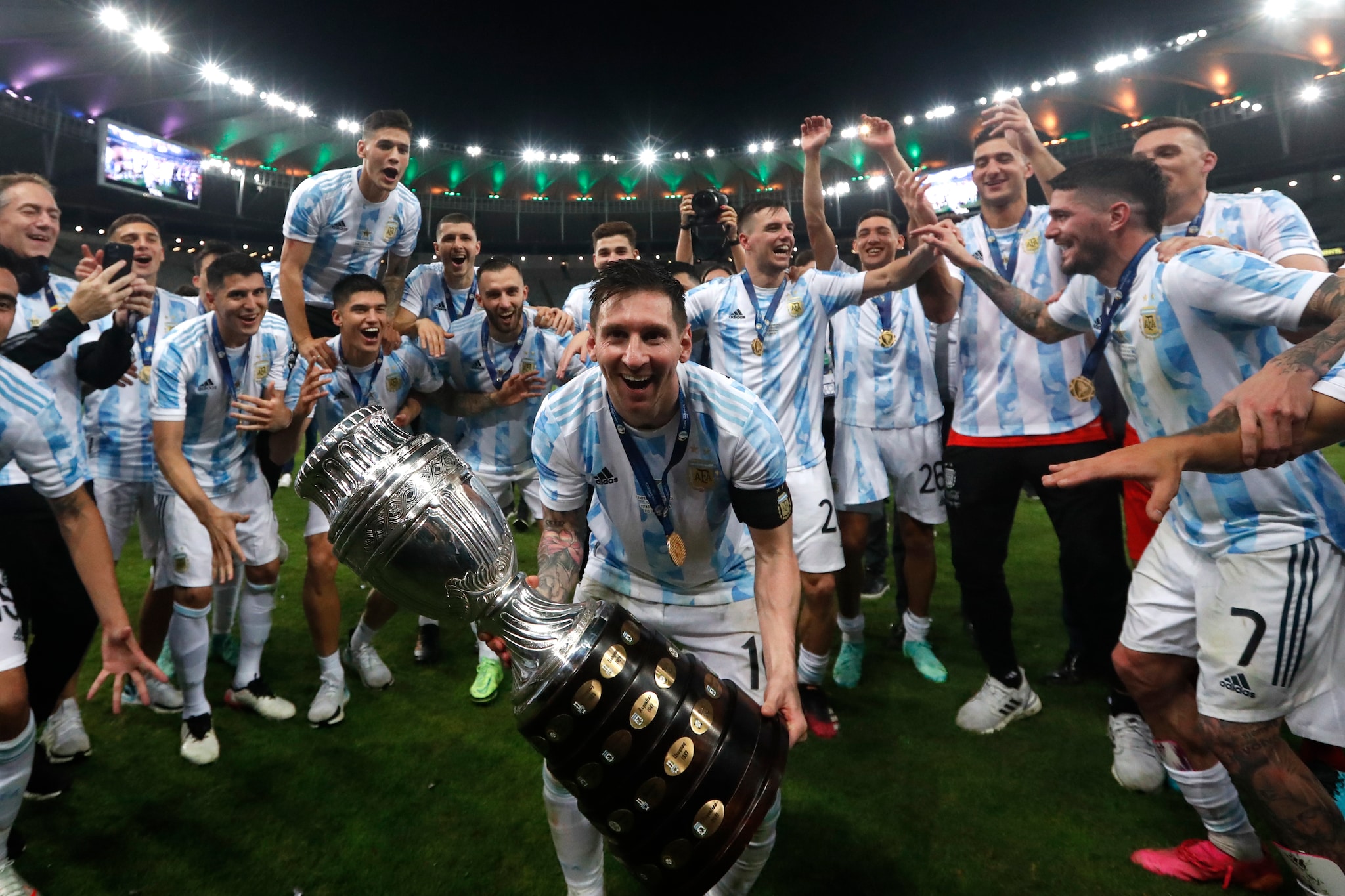 Argentina's Lionel Messi celebrates with the trophy after beating Brazil 1-0 in the Copa America final soccer match at the Maracana stadium in Rio de Janeiro, Brazil, Saturday, July 10, 2021. (AP Photo/Bruna Prado)