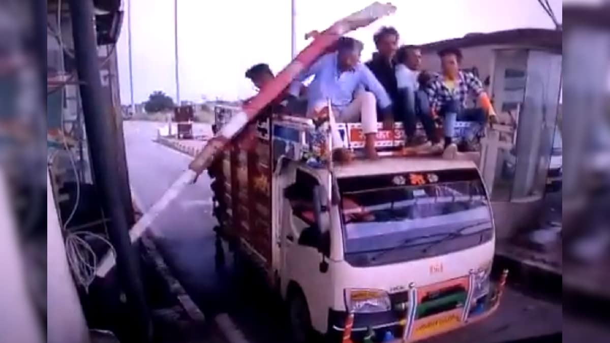 Watch: Hilarious Video Shows Toll Barrier Hitting People Sitting Atop a Mini Truck