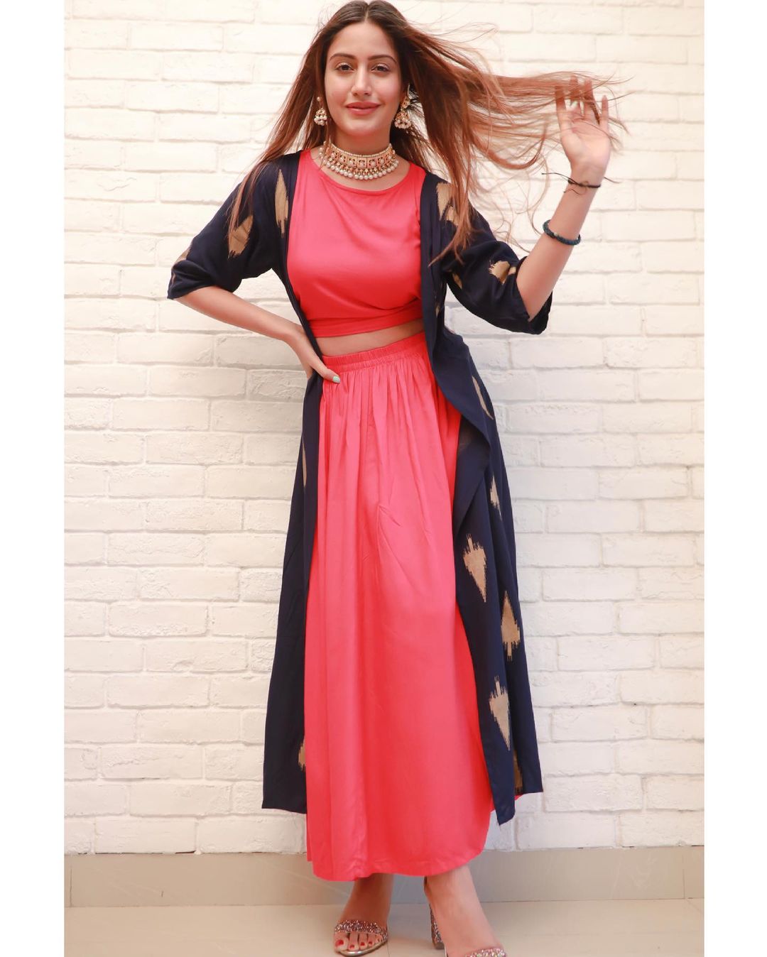  Surbhi Chandna looks charming in the plain pink ensemble by accessorising it with ornate jewellery. (Image: Instagram)