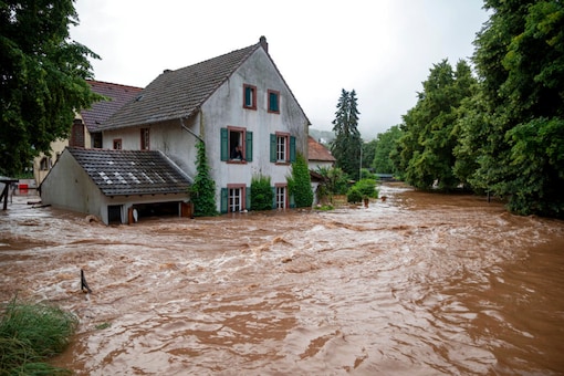 Houses are submerged on the overflowed river banks in Erdorf, Germany, as the village was flooded Thursday, July 15, 2021. Continuous rainfall has flooded numerous villages and cellars in Rhineland-Palatinate, southwestern Germany. (Harald Tittel/dpa via AP)