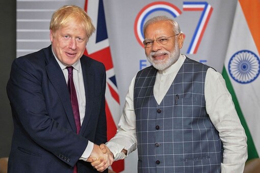 Boris Johnson held up the leaflet showing him in a handshake with Prime Minister Narendra Modi at the G7 Summit in 2019 with the message 'Don't risk a Tory MP who is not on your side.'