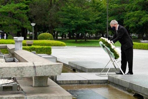 IOC president Thomas Bach offers flowers to Hiroshima Memorial Cenotaph (AP)