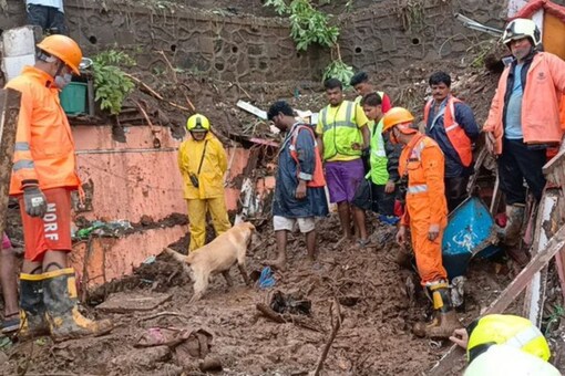 NDRF personnel look for people trapped after houses collapsed following heavy rains in Mumbai.
