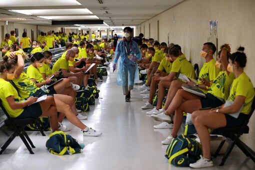 Australian team wait to take the quantitative coronavirus antigen test after arriving at Narita International Airport in Tokyo (Reuters)