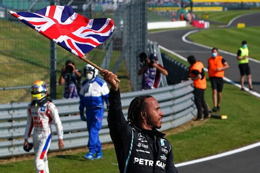 Mercedes driver Lewis Hamilton of Britain celebrates after winning the British Grand Prix (AP)
