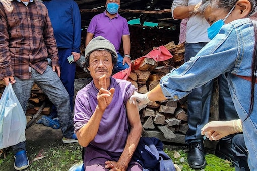 A medic administers a dose of COVID-19 vaccine to a beneficiary during a mop-up drive at Lumla in Tawang district. (PTI)