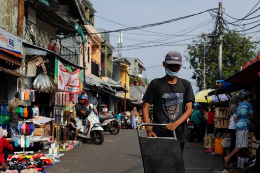 A man wearing a protective mask pushes a trolley at a traditional market amid the coronavirus disease (COVID-19) outbreak, in Jakarta, Indonesia