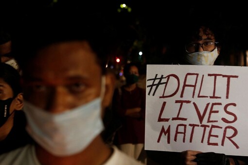 A man holds a placard during a protest after the death of a rape victim, on a street in Mumbai, India, September 30, 2020. REUTERS/Francis Mascarenhas
