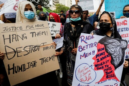 People carry signs against the killing of Noor Mukadam, 27, daughter of former Pakistani diplomat, and to condemn the violence against women and girls during a protest in Karachi, Pakistan July 25, 2021. REUTERS/Akhtar Soomro