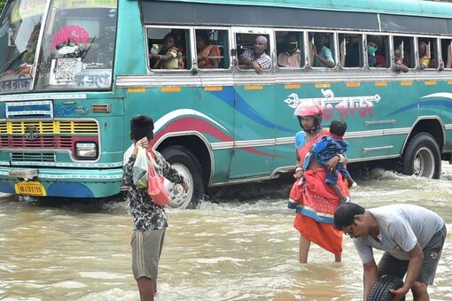 Hooghly: Vehicles wade through a flooded road after overflow of river Damodar and Mundeswari in Hooghly district, Monday, Aug 2, 2021. (PTI Photo/Swapan Mahapatra)(