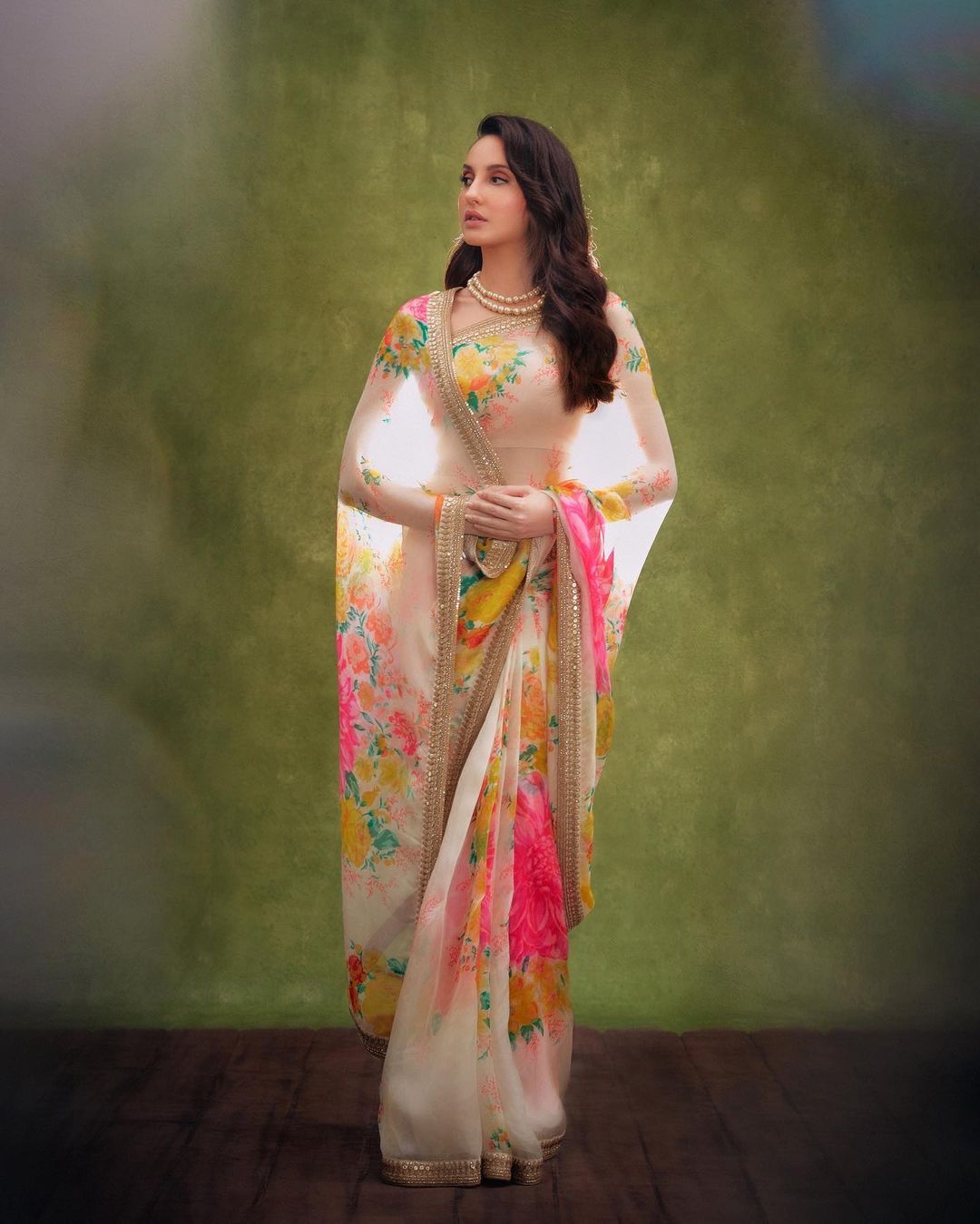Nora Fatehi looks grace personified in the vibrant floral saree. 