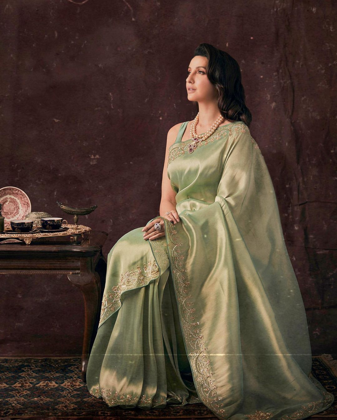 Nora Fatehi looks regal in the green silk wonder. 
