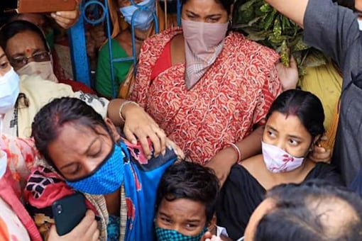 BJP President Nadda consoles a woman who lost her family member in the post-poll violence in Bengal in May 2021.  (File photo: PTI)