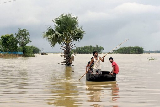 Murshidabad: Villagers affected by flood move towards a safer place, at Sona Bharui village.
