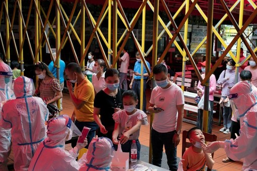 Residents line up for nucleic acid testing following a new COVID-19 case in Haikou in China's Hainan province. (Reuters)
