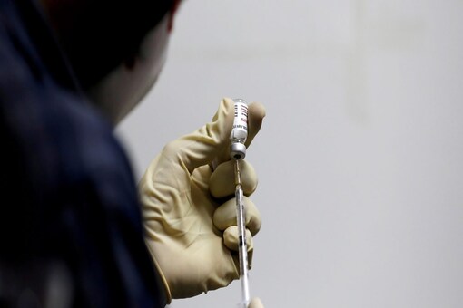 FILE PHOTO: A medic fills a syringe with COVAXIN, an Indian government-backed COVID-19 vaccine, before administering it to a health worker during its trials, at the Gujarat Medical Education and Research Society in Ahmedabad, India, November 26, 2020. REUTERS/Amit Dave/File Photo
