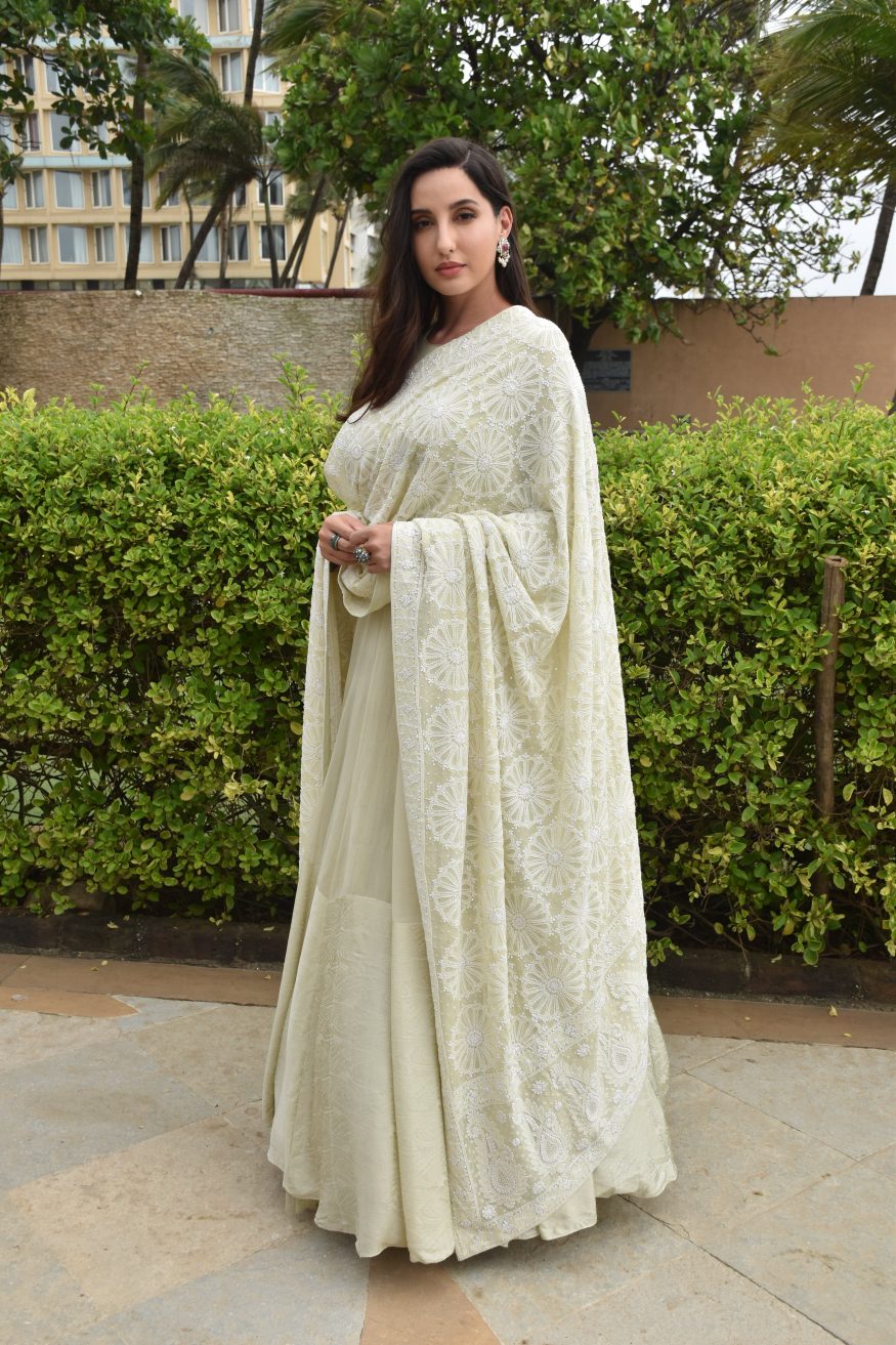 Nora Fatehi strikes a pose for the paparazzi in the embroidered dupatta and floor-length anarkali. 