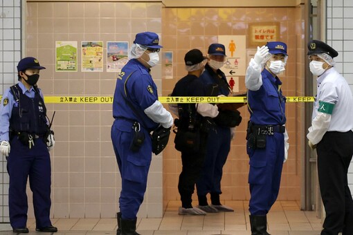 Police officers work at the site where a stabbing incident occurred on a train, at the Soshigaya-Okura station of the Odakyu Electric Railway in Setagaya Ward, Tokyo.