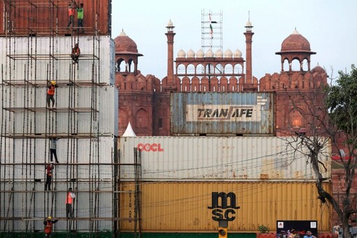 People work on containers placed in front of the Red Fort ahead of India's Independence Day celebrations, in the old quarters of Delhi, India August 5, 2021. REUTERS/Anushree Fadnavis