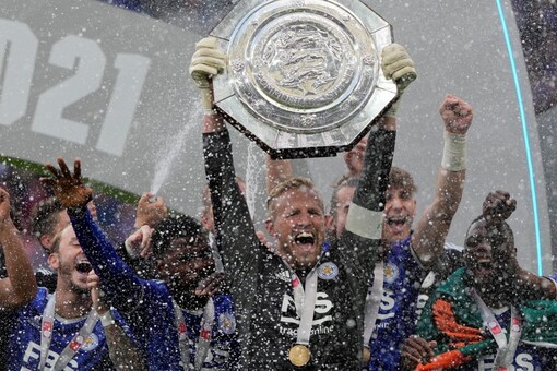 Leicester's goalkeeper Kasper Schmeichel lifts the trophy after winning the English FA Community Shield (AP)