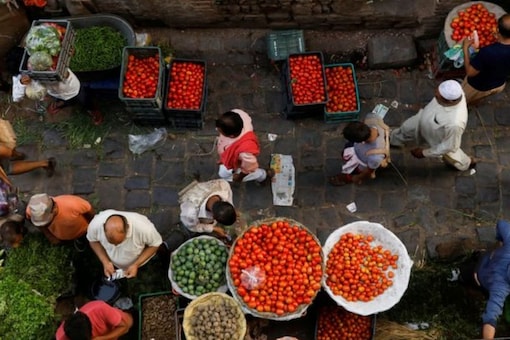 People shop at a crowded wholesale vegetable market in the old quarters of Delhi. (Image: Reuters)