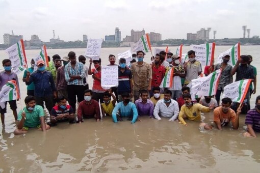 They walked into the river and stood in the knee-deep water as a symbolic protest to the attack.  Image: News18