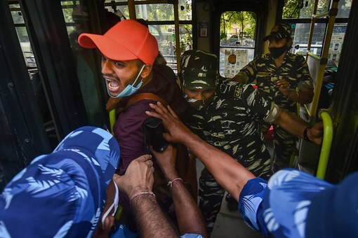 Security personnel detain a demonstrator during a protest against 'Call for Peace' rally at Jantar Mantar in New Delhi, Tuesday, Aug 10, 2021. (PTI Photo/Arun Sharma)