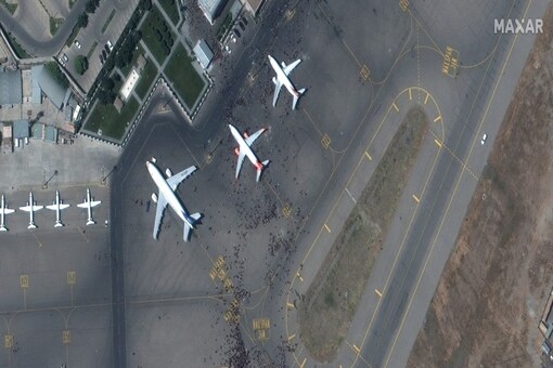 FILE PHOTO: Crowds of people are seen on the tarmac at Kabul's airport in Afghanistan August 16, 2021. SATELLITE IMAGE 2021 MAXAR TECHNOLOGIES/Handout via REUTERS.