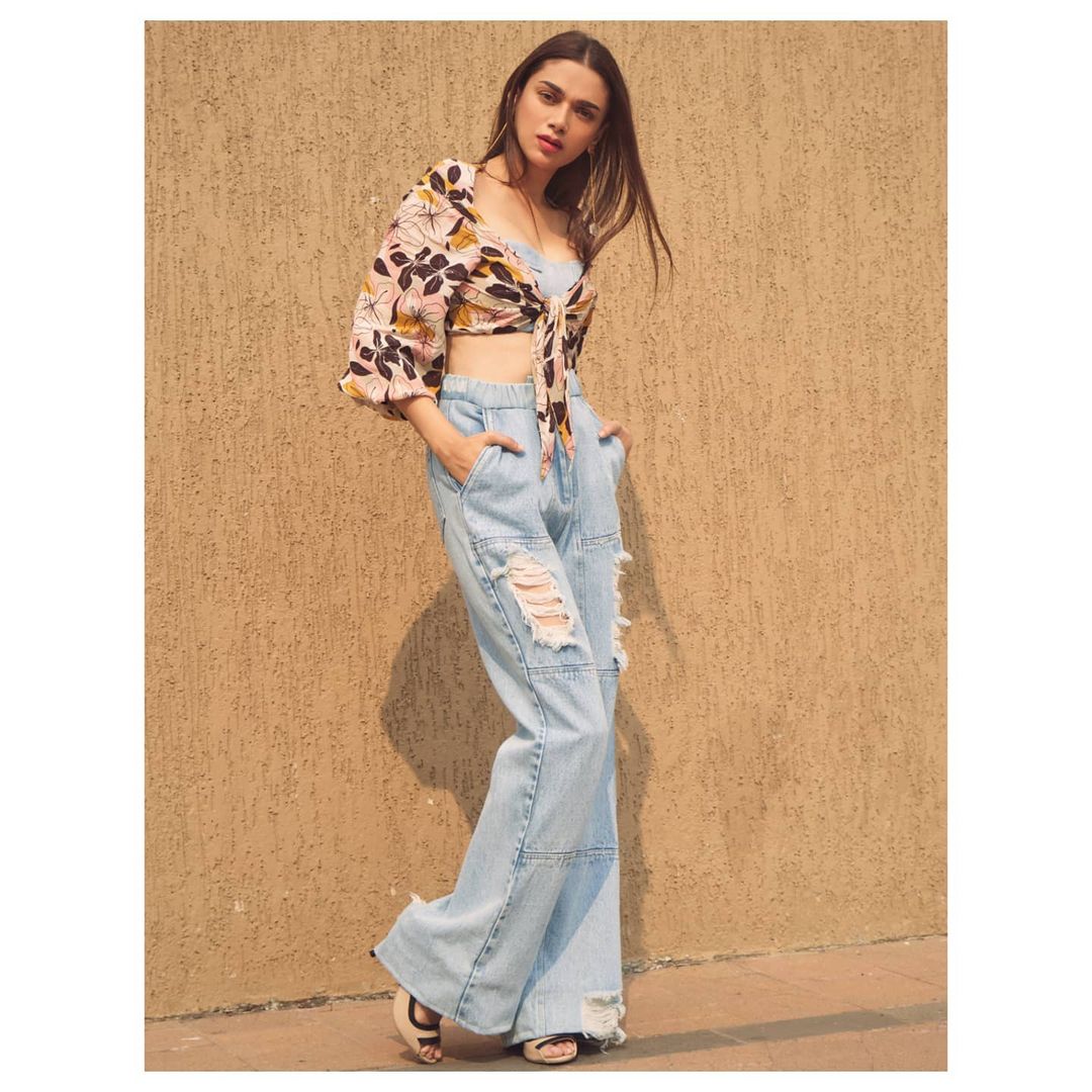 Aditi Rao Hydari gives a boho chic vibe in the ripped jeans and knotted top.