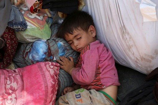 Internally displaced families from northern provinces, who fled from their homes due the fighting between Taliban and Afghan security forces, take shelter in a public park in Kabul. (Reuters)