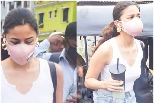 Alia Bhatt in white top and ripped denims with disposable coffee mug in hand