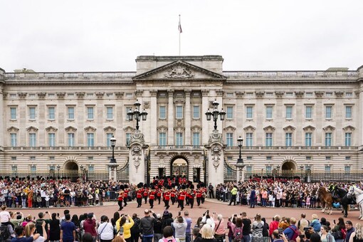 Members of the public watch the Changing of the Guard ceremony at Buckingham Palace, London, Monday August 23, 2021. (AP)