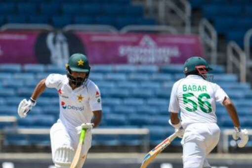 Pakistan's Fawad Alam (left) and Babar Azam (c) score runs from West Indies' Alzarri Joseph (r) on the first day of the second Test match between West Indies and Pakistan on August 20, 2021 at Sabina Park, Kingston, Jamaica.  (Photo by Randy Brooks/AFP) (Photo by Randy Brooks/AFP via Getty Images)