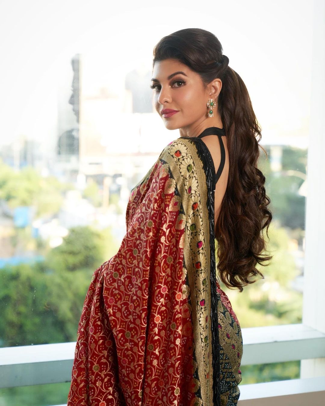 Jacqueline Fernandez looks graceful in the red and golden saree.