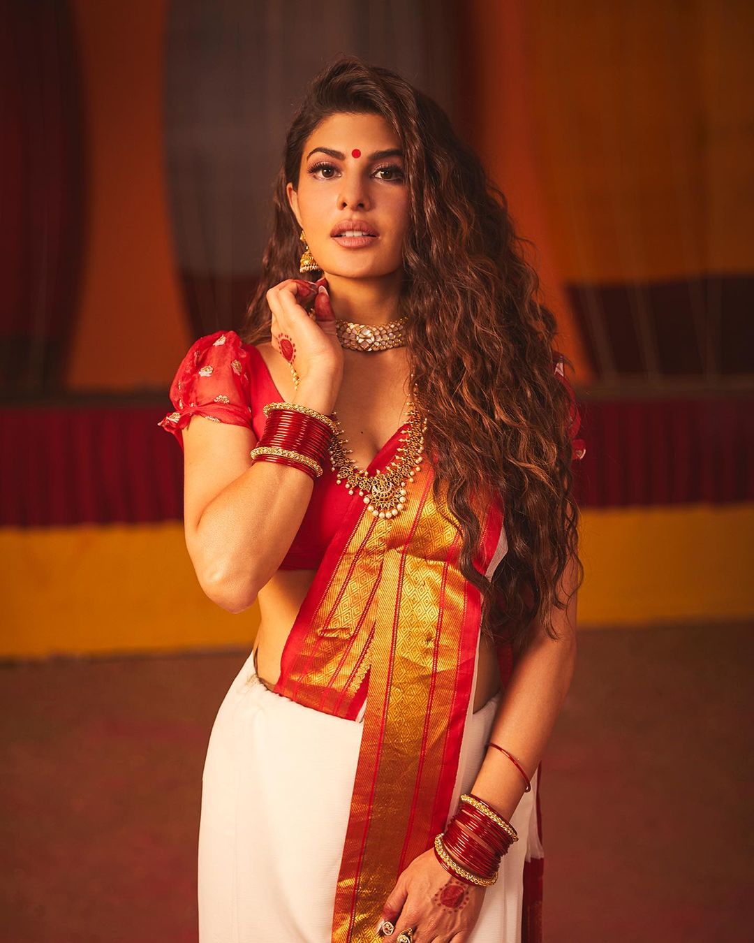 Jacqueline Fernandez turns up the heat in the white and red saree.