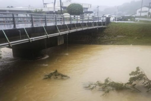 A swollen river caused by a heavy rain is seen in Nagomi Town, Kumamoto prefecture, Japan August 12, 2021, in this photo taken by Kyodo. Mandatory credit Kyodo/via REUTERS
