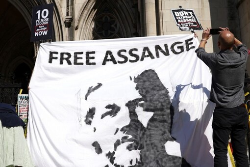 Supporters of Wikileaks founder Julian Assange display a banner outside the Royal Courts of Justice during the U.S. government appeal against a ruling by a British judge that Assange should not be extradited, in London, Britain August 11, 2021. REUTERS/Henry Nicholls