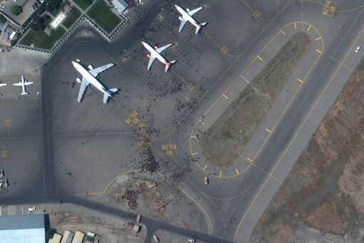 FILE PHOTO: Crowds of people are seen on the tarmac at Kabul's airport in Afghanistan August 16, 2021. SATELLITE IMAGE 2021 MAXAR TECHNOLOGIES/Handout via REUTERS.

