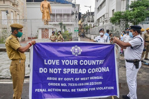 Police personnel fix a banner outside Swami Vivekananda's ancestral house in Kolkata, Thursday. (PTI)
