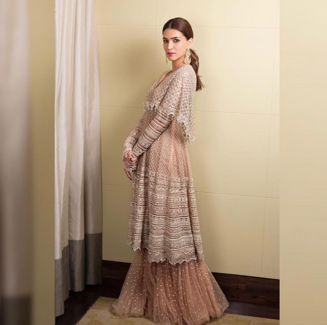 Kriti Sanon paints a graceful picture in the jacket and sharara. 