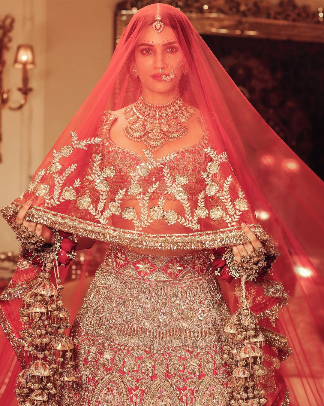 Kriti Sanon looked breathtaking in the heavily embellished red lehenga. 