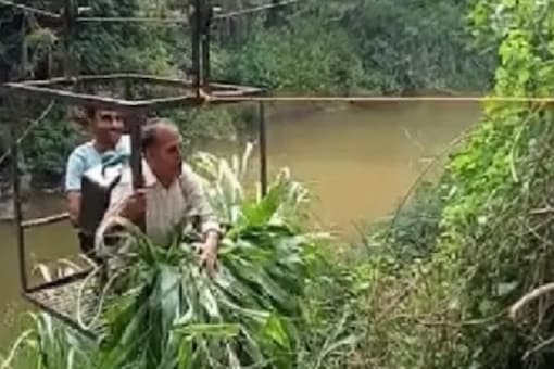 Due to heavy downpour, dozens of villages in the district get cut off from nearby places. (Image: News18) Due to heavy downpour, dozens of villages in the district get cut off from nearby places. (Image: News18)
