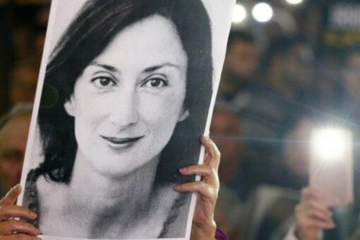 FILE PHOTO: People gather at the Great Siege Square calling for the resignation of Joseph Muscat following the arrest of one of the country's most prominent businessmen as part of the investigation into the murder of journalist Daphne Caruana Galizia, in Valletta, Malta November 20, 2019. REUTERS/Guglielmo Mangiapane/File Photo
