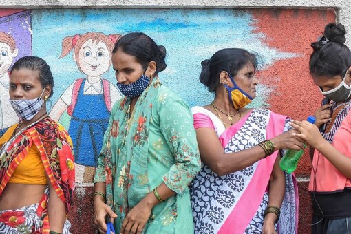 Beneficiaries wait in a queue to receive Covid-19 vaccine dose, at a vaccination centre in Mumbai, Thursday. (PTI)