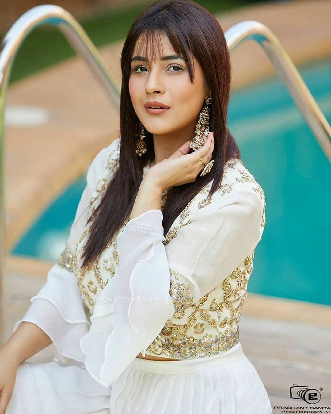 Shehnaaz Gill works her charm in the white and golden outfit. 