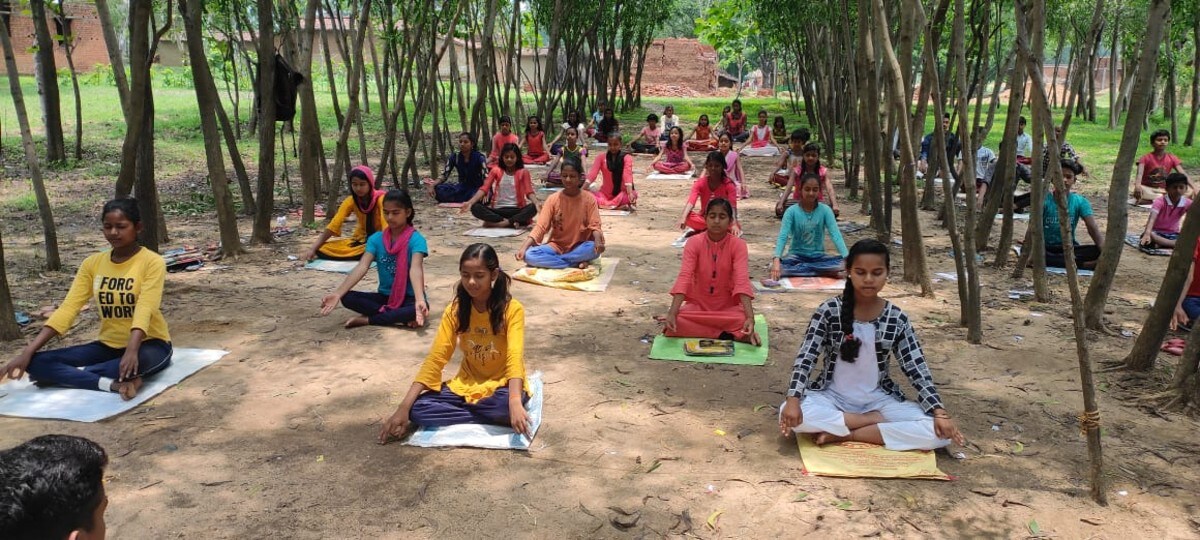 Students practising yoga in between lessons. (Image: S Sharma)