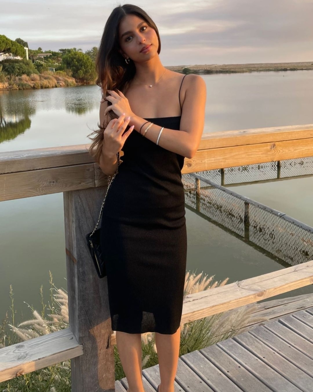 Suhana Khan looks gorgeous in the black dress against the sunset hues.